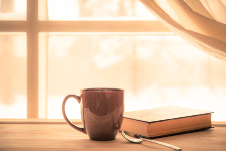 52314615 - coffe and book near window with bright sunny light